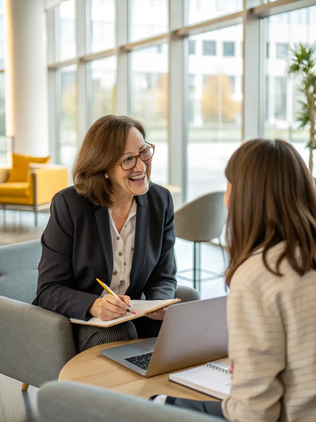 A professional executive in a modern office setting, confidently reviewing career growth plans with a coach, symbolizing strategic career development.